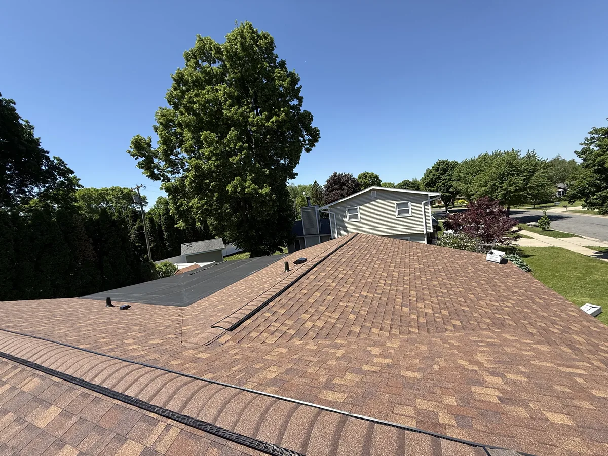 Brown architectural shingles going on a roof plane