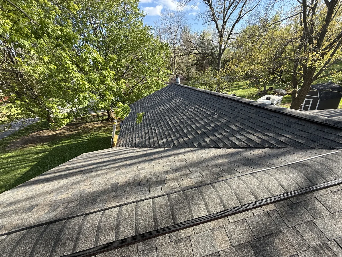 Dark gray architectural shingle roof on a hip roof