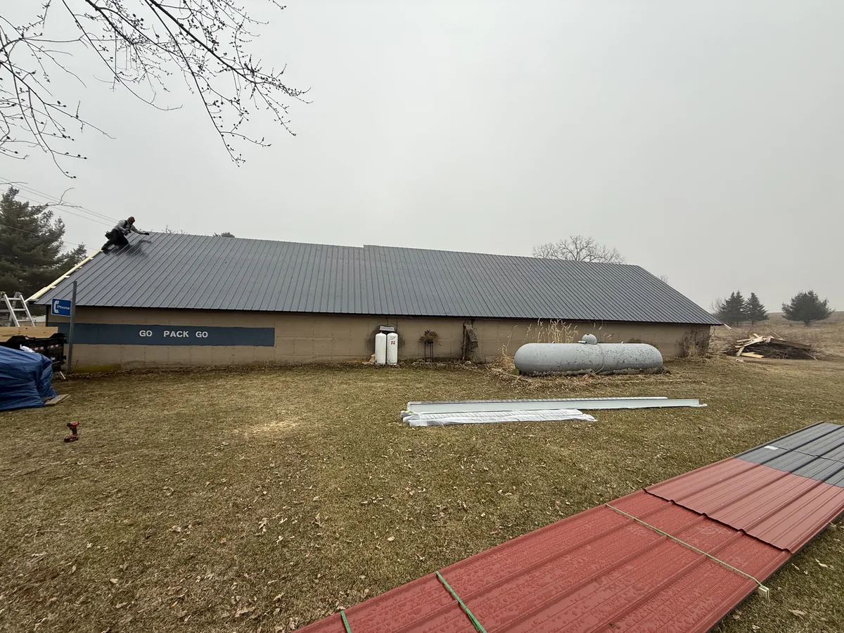 Gray metal roof on a long pole barn outbuilding