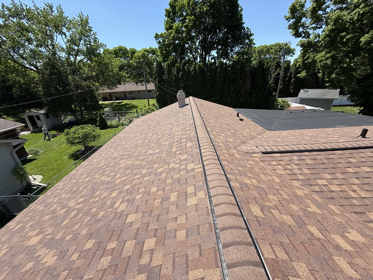 Brown shingle roof with ridge cap shingles