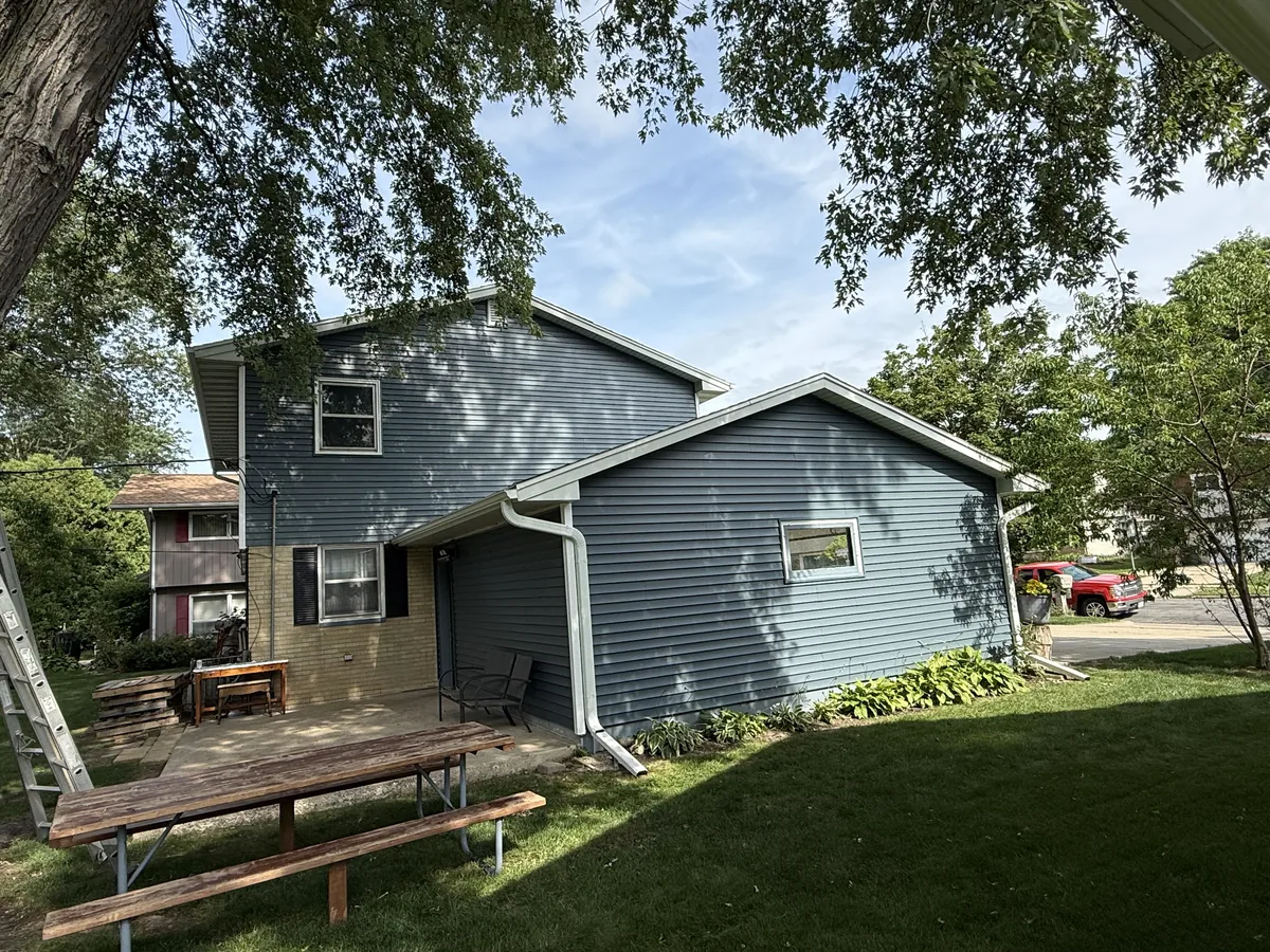 Blue gray siding and a new roof on a two story home