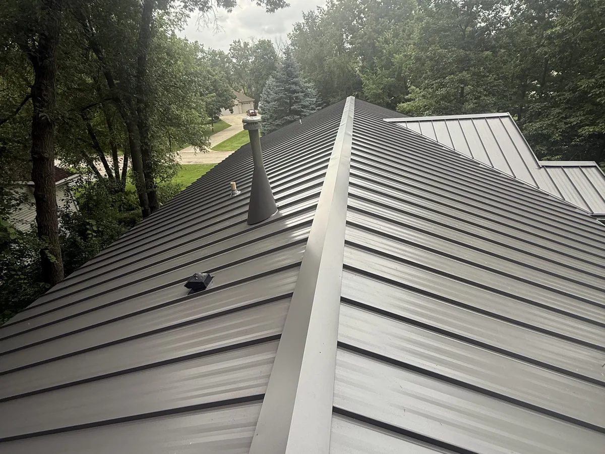 Tan standing seam metal roof along the ridge line