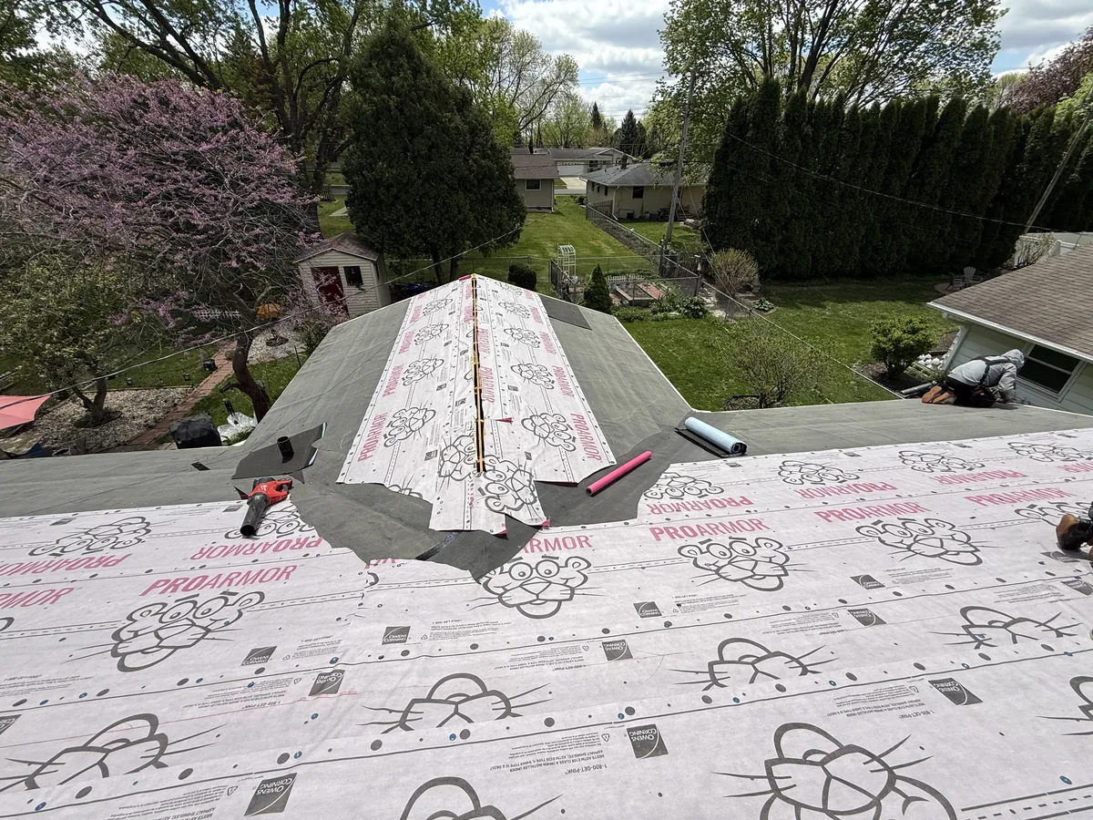 Synthetic roof underlayment covering a roof deck