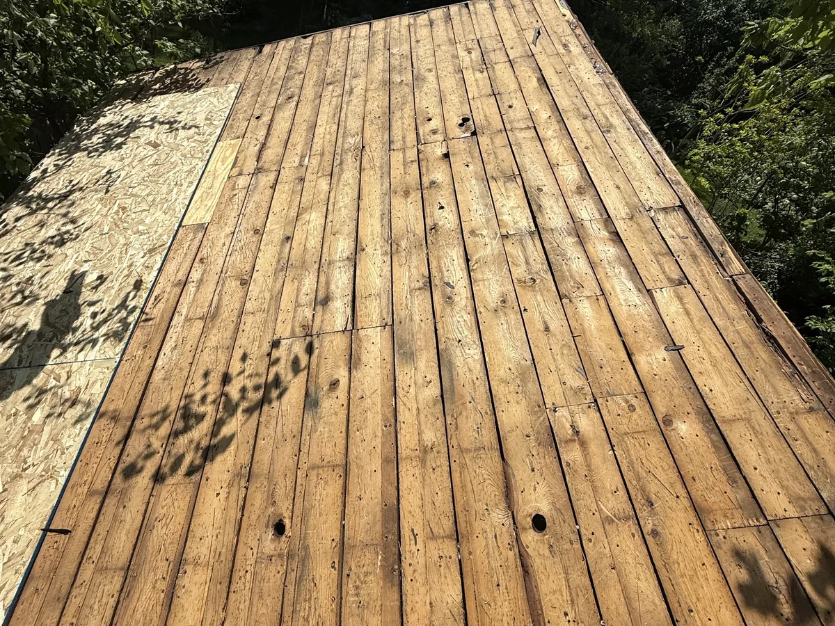 New wood deck boards fastened across a deck frame